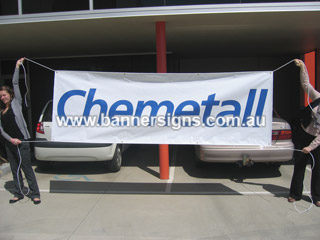 Small portable outdoor banner sign with ropes and eyelets