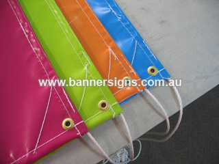 signs and banners with corner reinforcing and stitching into full length rope